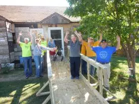 Provided photo: Diane R., 62, celebrates with Texas Ramp Project volunteers Saturday after receiving an access ramp.